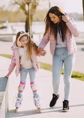 Woman with daughter roller blading