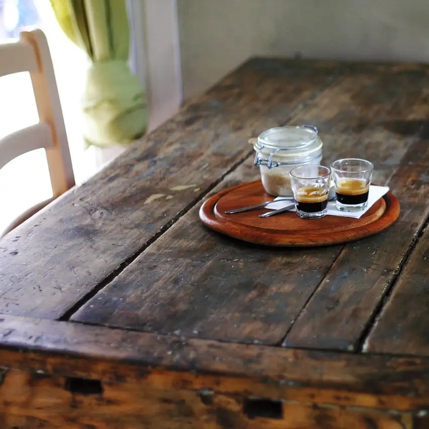 Rustic table with espresso and sugar on it